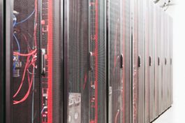 Modern data server room with network racks and cables.