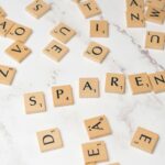 Scrabble tiles scattered on a marble surface depicting creativity and wordplay.