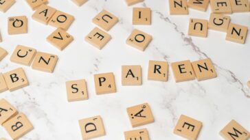 Scrabble tiles scattered on a marble surface depicting creativity and wordplay.