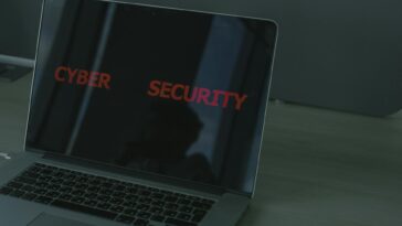 Close-up of a laptop displaying cybersecurity text, emphasizing digital security themes.