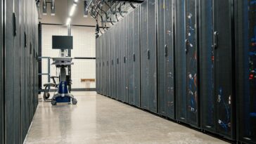 Modern data center corridor with server racks and computer equipment. Ideal for technology and IT concepts.