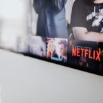 Selective focus of a Netflix screen on a smart TV in an indoor setting.