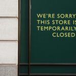 A photo of a store facade with a sign indicating temporary closure due to unforeseen circumstances.
