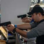 Group of men engaged in an indoor shooting game in Zagreb, showcasing hobby and leisure.
