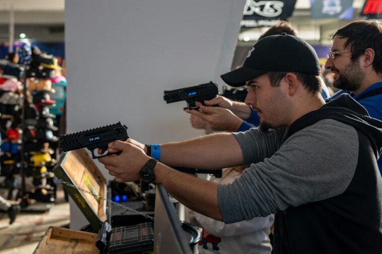Group of men engaged in an indoor shooting game in Zagreb, showcasing hobby and leisure.