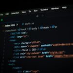 Close-up of HTML code displayed on a computer screen in dark mode, focusing on programming concepts.