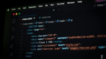 Close-up of HTML code displayed on a computer screen in dark mode, focusing on programming concepts.