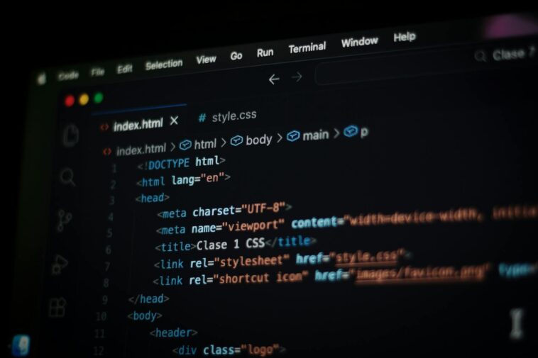 Close-up of HTML code displayed on a computer screen in dark mode, focusing on programming concepts.