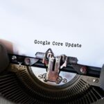 Close-up of a typewriter typing 'Google Core Update' on paper, symbolizing digital advancement.