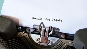 Close-up of a typewriter typing 'Google Core Update' on paper, symbolizing digital advancement.