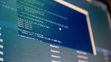 From below of monitor of modern computer with opened files on blue screen