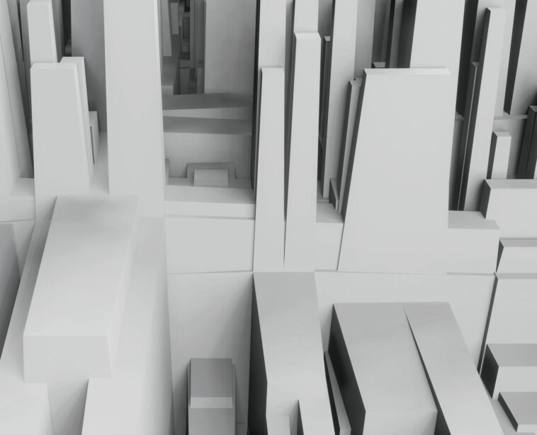 Aerial view of a 3D abstract cityscape with geometric shapes in grayscale tones.