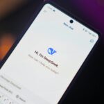 Close-up of a smartphone showing AI chat interface with digital assistant DeepSeek.