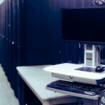 A modern data center featuring a computer setup with monitor and keyboard, emphasizing technology infrastructure.