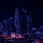Stunning night cityscape showcasing towering skyscrapers in vibrant lights.