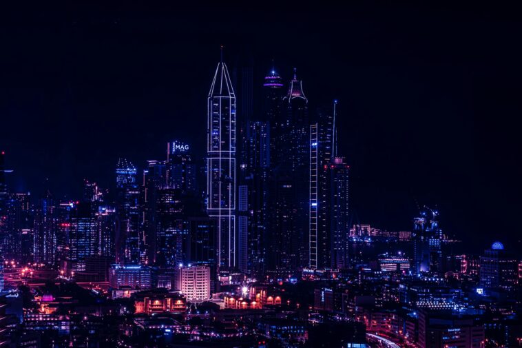 Stunning night cityscape showcasing towering skyscrapers in vibrant lights.