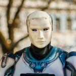 Close-up of a humanoid robot with a futuristic design posing outdoors.
