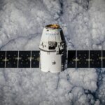 SpaceX Dragon spacecraft in orbit, highlighting advanced space technology with cloud backdrop.
