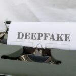 Old-fashioned typewriter with a paper labeled 'DEEPFAKE', symbolizing AI-generated content.